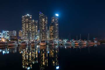 Busan city skyline view at Haeundae district, Gwangalli Beach with yacht pier at Busan, South Korea.