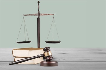 Justice Scales and books and wooden gavel on table. Justice