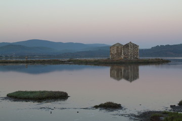 Fototapeta na wymiar ruined stone house and reflection