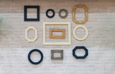 Beautiful of wooden frame, various shapes on a white brick wall