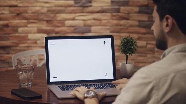 Business man working in modern office cafeteria. Latin businessman with pc at corporate job. Busy hispanic manager with laptop computer at work. Screen and monitor for technology, internet and website