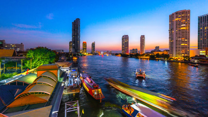 Night view of Bangkok at Saphan Taksin pier,Thailand.