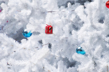 Decorated White Christmas tree with red gift box, blue red ball.
