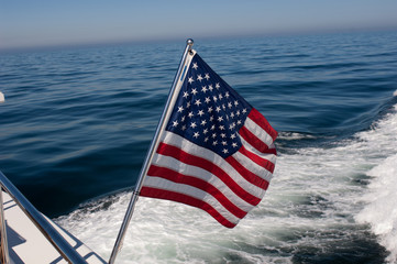 american flag of united states of america on stern of yacht