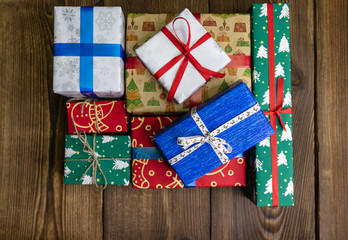 background. Gifts in festive color packaging, lie on a wooden floor. New Year, Christmas, Saint Nicholas, Santa.