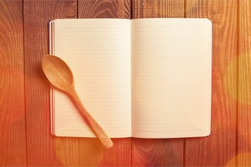 Empty notebook for recipes with spoon