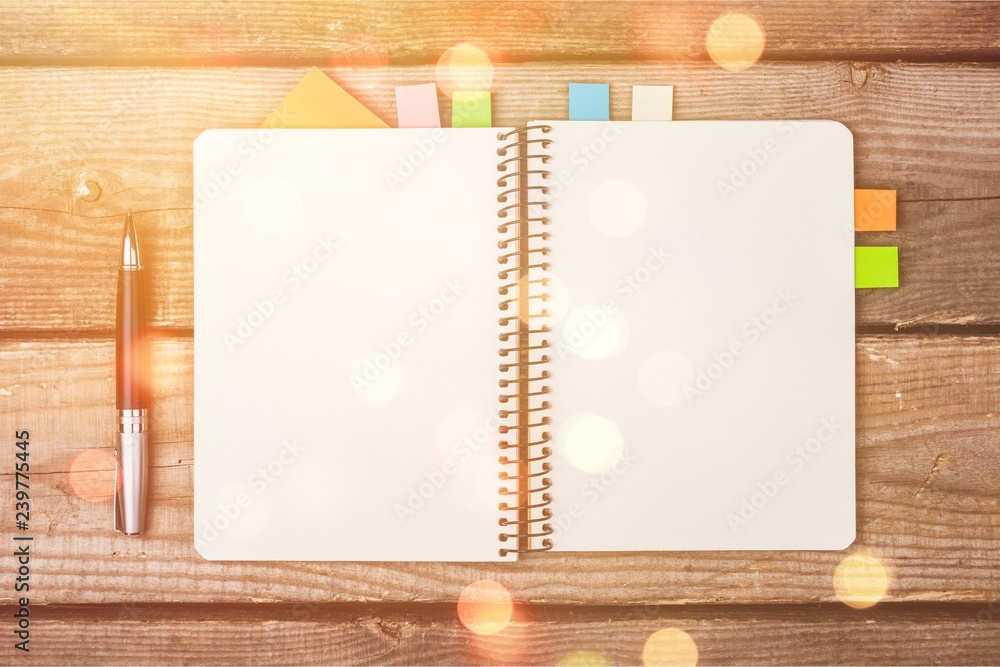 Poster Blank notebook and pen on wooden background