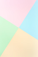 Background pastel colors: pink, yellow, blue, green. Geometric pattern papers. Minimal concept. Flat lay, Top view. 