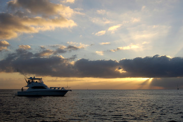 sportfishing boat on sea at sunset