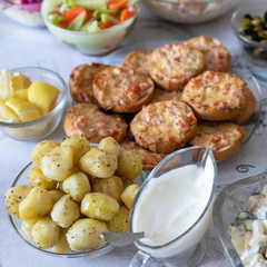 Food for the holiday of Christmas and New Year in Russia. Festive table. Various traditional dishes and snacks. View from above. Baked potatoes, salad, sandwiches