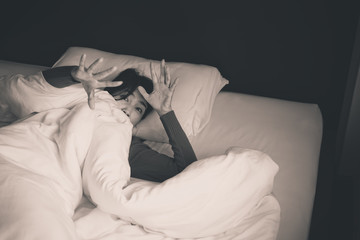 Nightmare or bad dream,Woman with scare and panic while lying down under the blanket in...