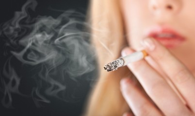 Portrait of the beautiful elegant girl smoking cigarette