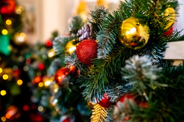 Decorative garland from christmas tree branches and cones. home decorated for winter holidays, little red and gold baubles. Copy space for wishes.Selective focus. Colorful christmas decorations.Happy