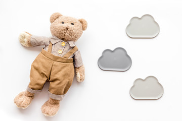 Baby care with craft toys for newborn. Teddy bear. White background top view