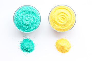 Colorful bath salt blue and yellow on white background top view