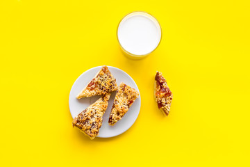 Drink milk with cookies concept. Cup of milk and fresh homemade cookies on yellow background top view space for text