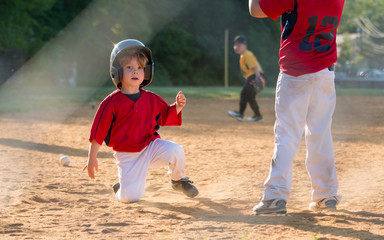 Young Baseball Player Sliding into Home Plate © J. Novack