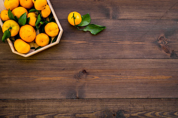 New Year and Christmas Eve with mandarins. Citrus winter fruits on wooden background top view space for text
