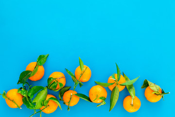 Obraz na płótnie Canvas New Year and Christmas Eve with mandarins. Citrus winter fruits on blue background top view space for text