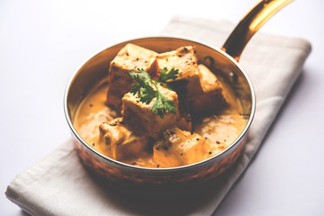 Malai or achari Paneer in a gravy made using Whipping Cream. served on a serving pan. selective focus