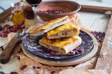 Lobiani - traditional dish of Georgian food. Baked closed pie or bread with white lobio or red beans filling. Eat for Barbaroba holiday or Christmas and New Year. Served with red whine, oil, ajika.