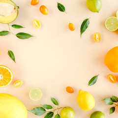 Fototapeta na wymiar Frame made of summer tropical fruits: orange, lemon, lime, mango on yellow background. Food concept. flat lay, top view