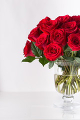 Bouquet of beautiful red roses on white isolated background in glass vase for Valentines day 14...