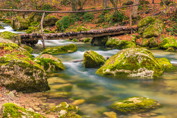 wooden bridge over a mountain river, beautiful autumn landscape