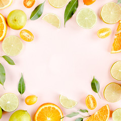 Frame made of summer tropical fruits: orange, lemon, lime, mango on pink background. Food concept. flat lay, top view