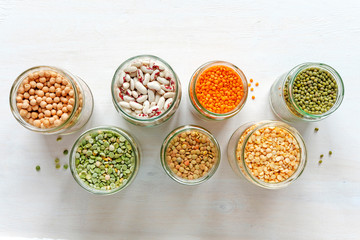 Glass jars full of assorted dried legumes