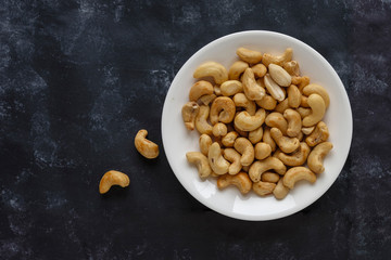 Roasted salted cashew nuts on a white plate