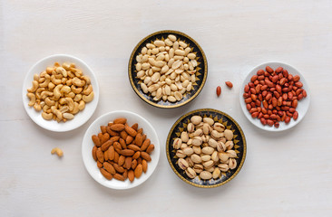Corner border of fresh nuts in bowls