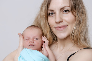 baby in the arms of the mother. Woman holding a child