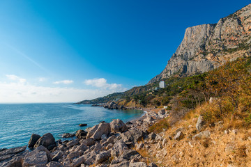 Fototapeta na wymiar rocky shore of a picturesque sea bay in the autumn sunny afternoon. Black Sea, Crimea