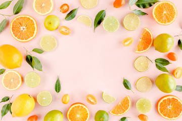 Frame made of summer tropical fruits: orange, lemon, lime, mango on pink background. Food concept. flat lay, top view