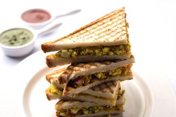 Paneer bhurji sandwich is a tasty paneer based dish made with cottage cheese.served with fresh tomato ketchup and green mint chutney. selective focus