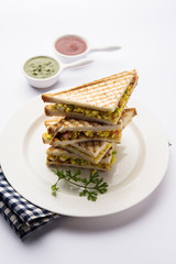 Paneer bhurji sandwich is a tasty paneer based dish made with cottage cheese.served with fresh tomato ketchup and green mint chutney. selective focus