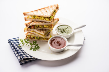 Paneer bhurji sandwich is a tasty paneer based dish made with cottage cheese.served with fresh tomato ketchup and green mint chutney. selective focus