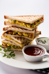 Paneer bhurji sandwich is a tasty paneer based dish made with cottage cheese.served with fresh tomato ketchup and green mint chutney. selective focus
