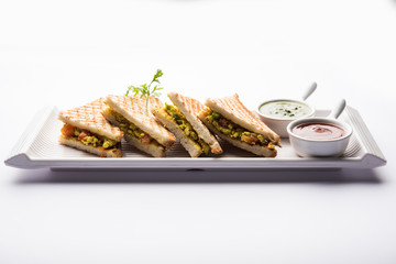 Paneer bhurji sandwich is a tasty paneer based dish made with cottage cheese.served with fresh tomato ketchup and green mint chutney. selective focus