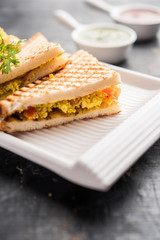 Paneer bhurji sandwich is a tasty paneer based dish made with cottage cheese.served with fresh tomato ketchup and green mint chutney. selective focus