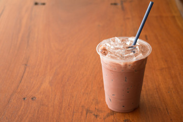 Iced chocolate milkshake, Summer refreshment drinks on wooden background in cafe