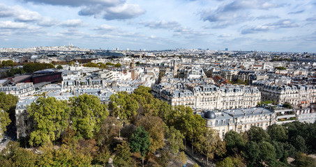 Fototapeta na wymiar Paris neighborhoods on partly cloudy day with sun