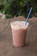 Iced chocolate milkshake, Summer refreshment drinks on wooden background in cafe