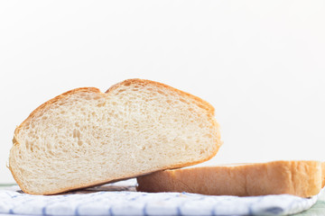 Fresh home made bread on white table background with napkin