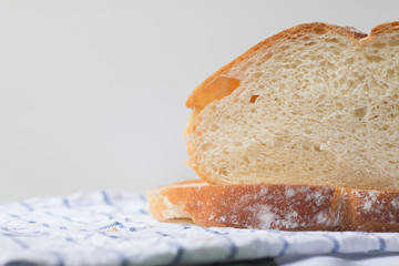 Fresh home made bread on white table background with napkin