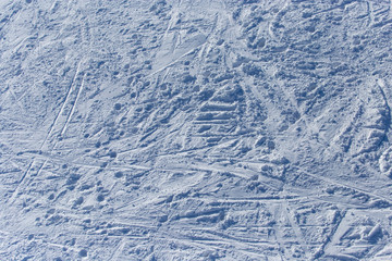 Traces of skiers on white snow in the mountains