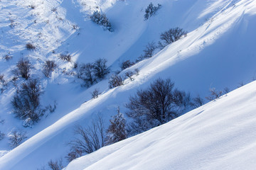White snow on the mountainside as a background