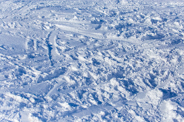 Traces of skiers on white snow in the mountains