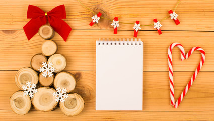 Wooden Christmas tree, notebook and candy heart.